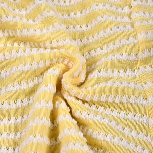 Close-up of yellow and white striped knit fabric with textured wavy pattern