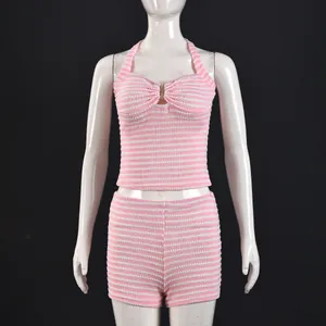 Detail of pink striped knit two-piece set with halter crop top and high waist shorts