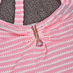Detail of pink and white striped knit top showing the V-cut neckline and fabric texture
