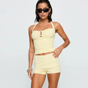 Detailed texture of yellow and white striped ribbed knit halter top and matching shorts
