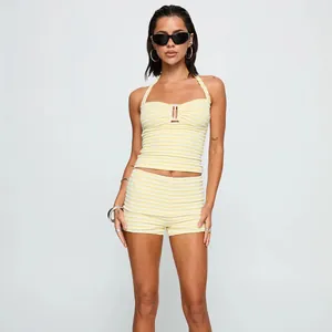 Detail view of yellow striped halter top and shorts set with textured fabric finish