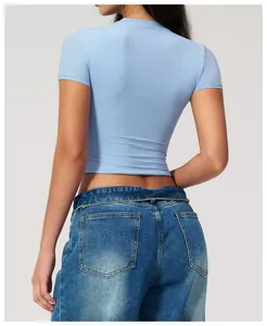 Close-up of slim-fit light blue yoga top paired with classic wash denim jeans back view