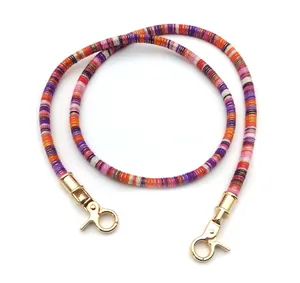 Close-up of colorful braided strap with gold lobster clasps for bags or phones