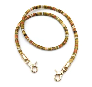 Detail of colorful disc bead strap with golden metal lobster clasps for bags or phones