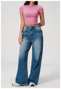 Detail of pink slim-fit cropped yoga top paired with high-waisted wide-leg jeans