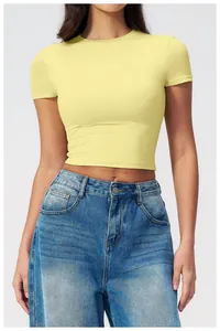 Close-up of the pale yellow slim fit crop top with round neck and soft texture