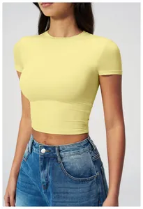 Close-up of tight-fitting light yellow yoga crop top with elastic knit texture