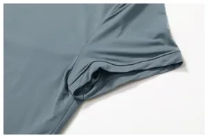 Macro view of blue-grey athletic shirt showing seamless stitching and fabric texture