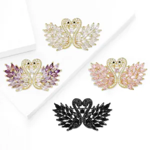 Elegant swan brooch with double swans forming a heart shape and cubic zirconia inlay