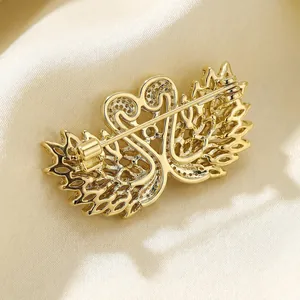 Exquisite gold-plated twin swan brooch with micro-pave cubic zirconia on silk