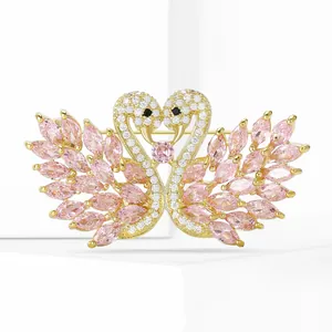 Detail of elegant gold-tone swan brooch with pink marquise zircon and pavé crystals