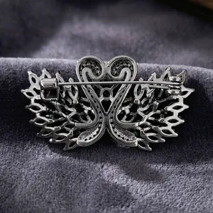Macro shot of the silver swan brooch back with secure pin clasp and metal casting