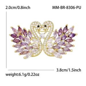 Elegant swan heart brooch with gold finish, cubic zirconia and purple crystals