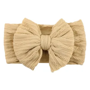 Elastic baby headband with jacquard knit bow in warm beige for toddlers