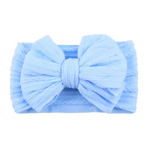 Elastic baby headband with jacquard knit texture and large bow in light blue