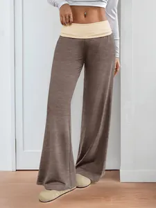 Detail of color block waistband and brown wide leg fabric on low waist trousers