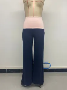 Detail view of navy wide leg trousers with a contrasting pink elastic waistband