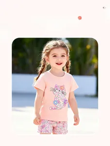 Detail of pink cotton t-shirt with floral cat patch and ruffled purple floral shorts