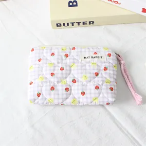 Detailed view of quilted lilac rabbit coin purse with pink tassel zipper puller