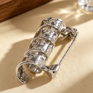 Macro view showing the hammer finish texture on the silver spiral tiered brooch