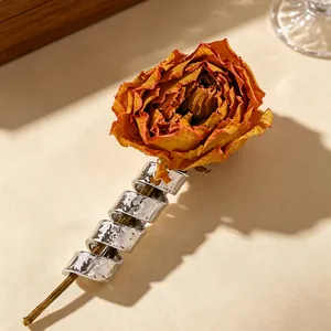 Artistic silver spiral brooch with hammered texture on a vintage rose stem detail