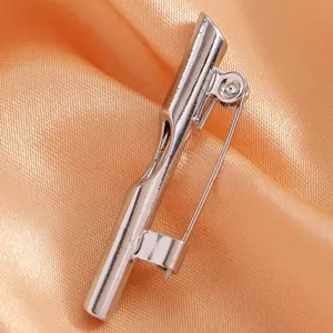 Macro shot of a silver metal floral pin base on silk fabric for DIY jewelry making