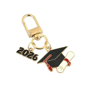 2026 graduation cap keychain with gold alloy carabiner and red tassel on white background