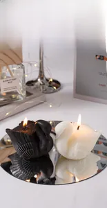 Macro detail of handmade swan scented candles with feather texture on mirror surface