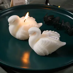 Elegant white swan scented candle pair on ceramic plate for romantic home decor