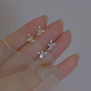 Detail of elegant butterfly stud earrings featuring water drop zircon stones