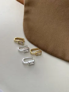 Close-up of S925 silver square zircon hoop earrings with smooth metallic finish