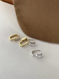 Close-up of S925 sterling silver hallmark on square zircon hoop earrings in gold and silver