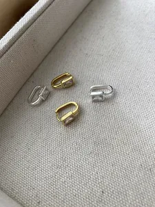 Macro detail of S925 hallmark on square zircon geometric U-shaped hoop earrings