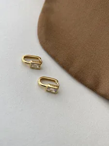 Macro shot of S925 sterling silver stamp on gold square zircon geometric hoop earrings