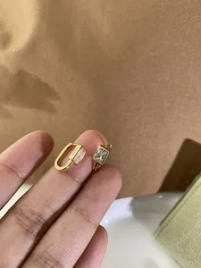 Macro view of gold S925 sterling silver hoop earrings with rectangular zircon stones