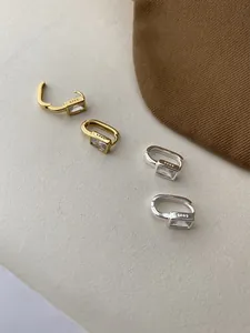 Close-up of S925 sterling silver stamp on minimalist square zircon hoop earrings