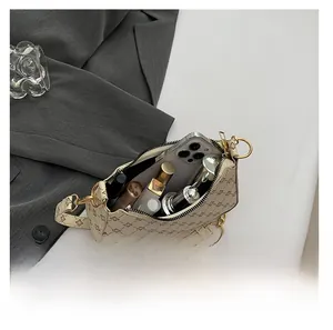 Top-down view of the large capacity interior for this printed crescent shoulder bag