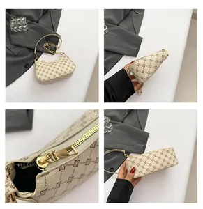 Detail view of beige crescent bag with floral print, gold chain and metal zipper