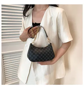 Detail of vintage geometric print on grey hobo shoulder bag with gold chain strap