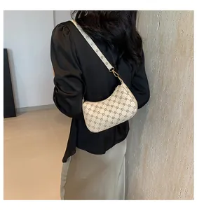 Model view of cream half-moon underarm bag with vintage geometric clover pattern