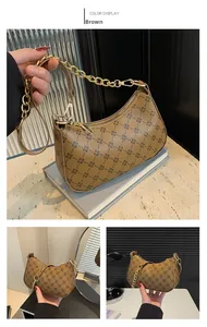 Detailed view of brown retro baguette bag with geometric print and gold chain strap