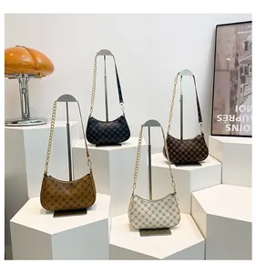 Detailed display of crescent bags in four colors with geometric print and chain straps