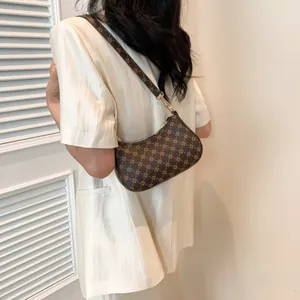 Vintage brown hobo shoulder bag with golden cross-star print and metal buckle