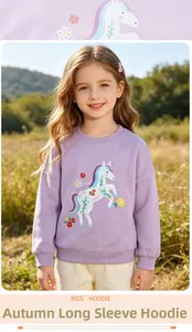 Detailed close-up of colorful unicorn and floral embroidery on a purple kids sweatshirt