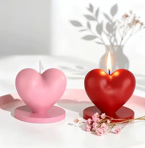 Pink and red heart-shaped scented candles with matching bases and soft flame detail
