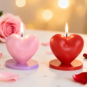 Romantic heart-shaped scented candles in pink and red with a stable round base