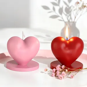 Pink and red heart-shaped scented candles with matching round bases in life scenes