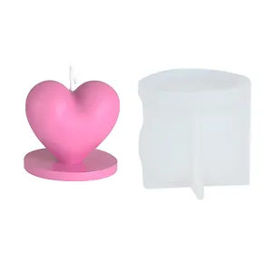 DIY heart candle silicone mold with finished pink candle and base on white background
