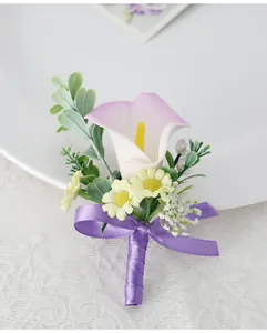 Detail of handmade white and purple calla lily boutonniere with ribbon and daisy