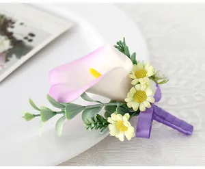 Detail of calla lily boutonniere with purple ribbon and small daisy flowers